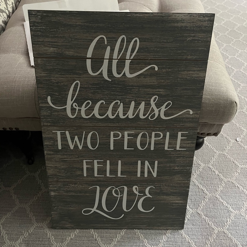 Wall art saying “all because two people fell in love”